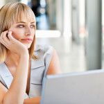 woman-bored-at-work-looking-out-window