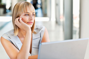 woman-bored-at-work-looking-out-window